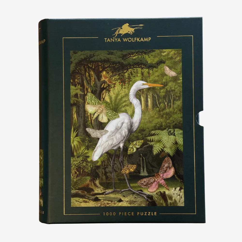 Jigsaw puzzle box with a heron and butterfly design on a white background