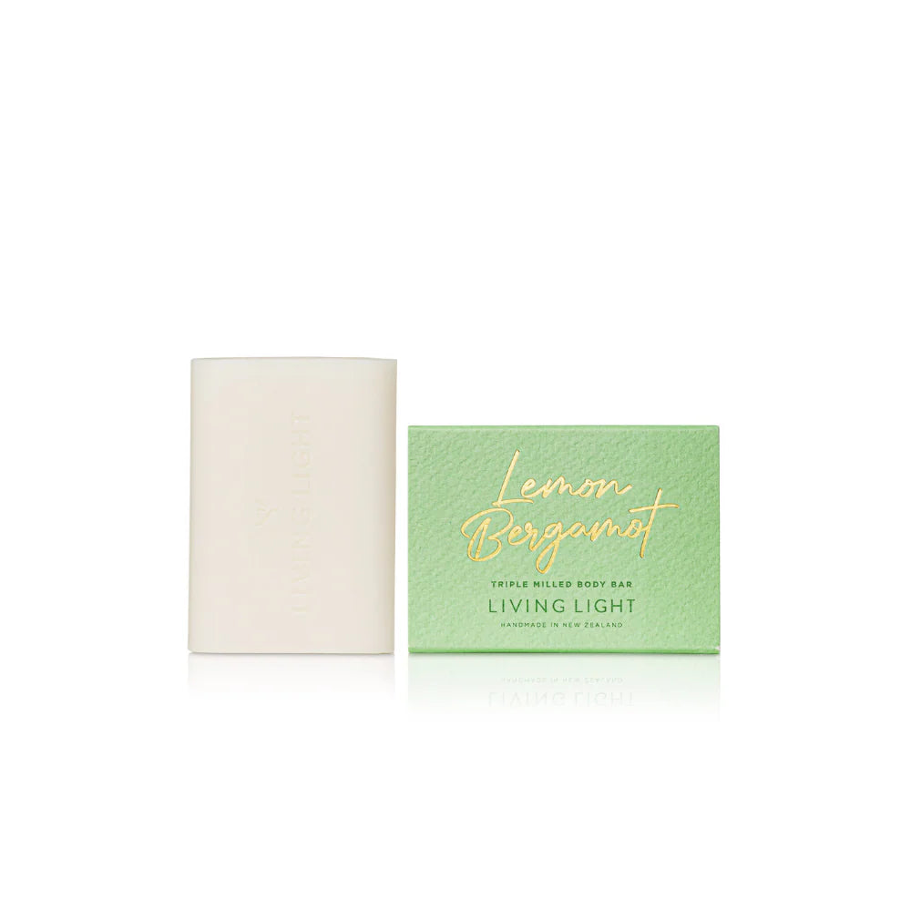 Two soap bars, one white and one green with 'Living Light' branding, on a white background.