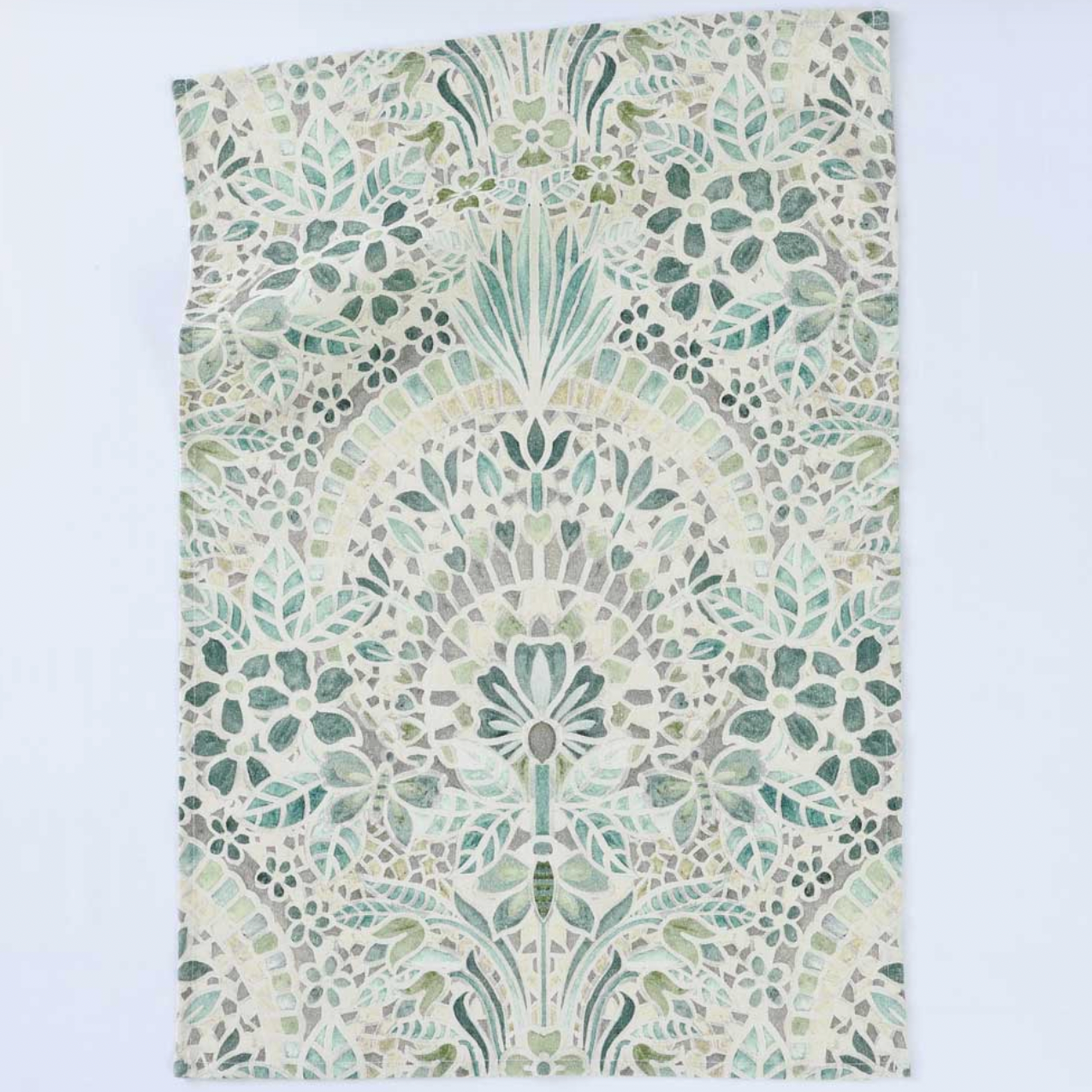 Decorative fabric with a green and beige pattern on a white background