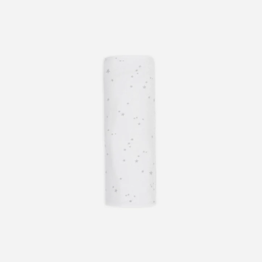 White cylindrical object with small black dots on a white background