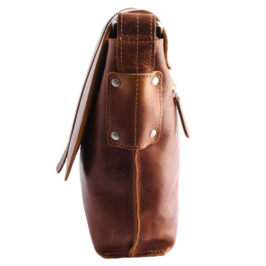 Brown leather bag with a strap on a white background