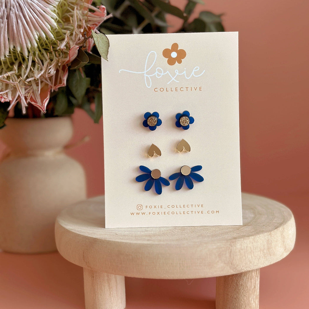 Set of floral earrings on a 'Foxie Collective' card with a pink background and flowers.