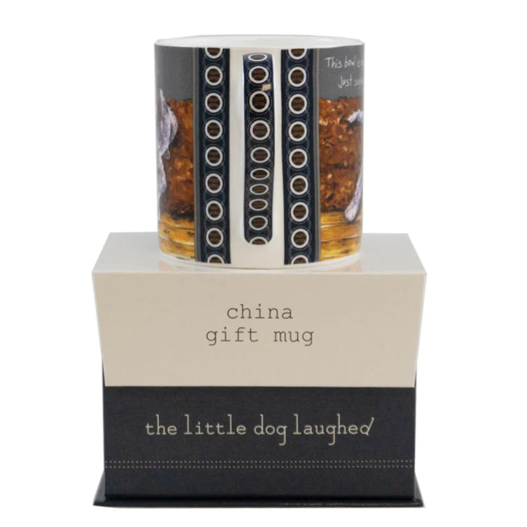 Ceramic mug with decorative design on a stand featuring 'the little dog laughed' branding.