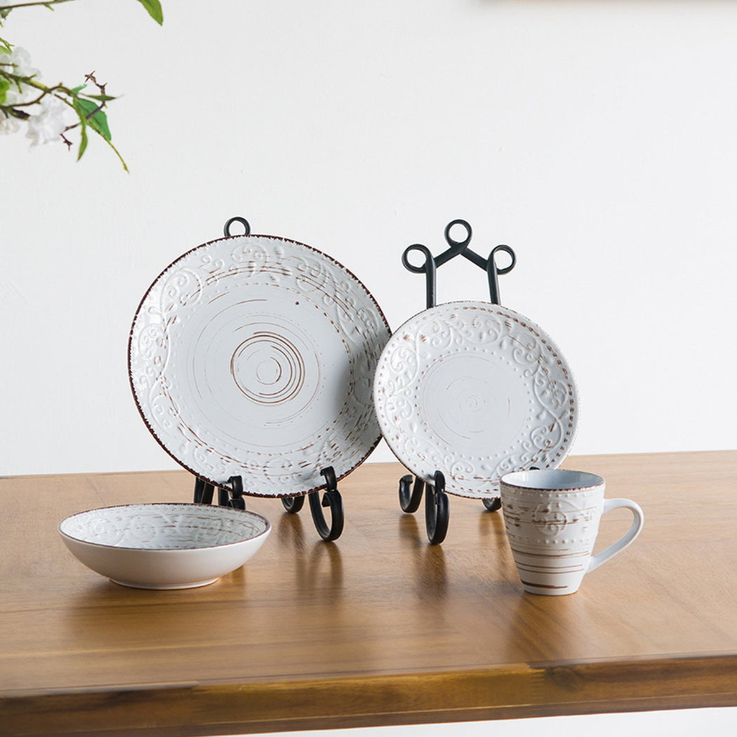 Ceramic tableware set on a wooden surface with a white background