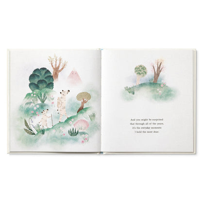 Open book with illustrations of trees and animals on a white background