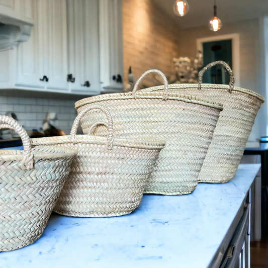Set of woven baskets on a kitchen counter with cabinets and appliances in the background