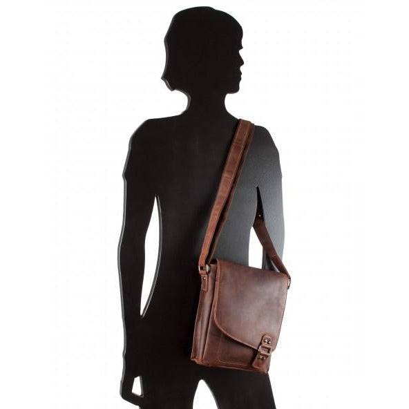 Mannequin silhouette wearing a brown leather shoulder bag on a white background
