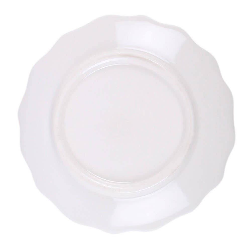 A white ceramic plate with a scalloped rim, shown from a top-down perspective on a solid white background.