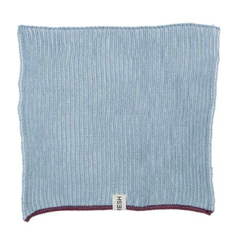 Blue textured fabric square with a brand label on a white background