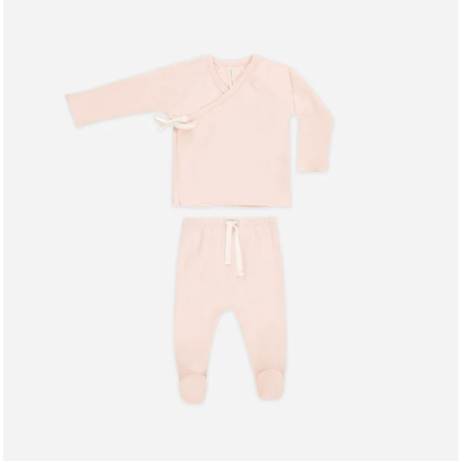 Pink baby onesie with long sleeves and legs on a white background