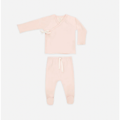 Pink baby onesie with long sleeves and legs on a white background