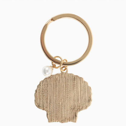 Gold keychain with a textured pendant and pearl charm on a white background