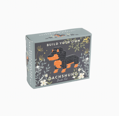 Box for building a dachshund model with floral designs on a white background