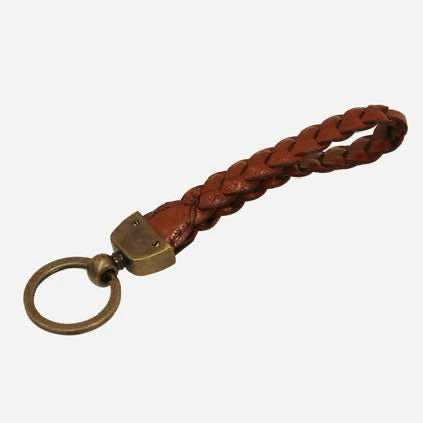 Brown braided leather keychain with brass clasp on a white background