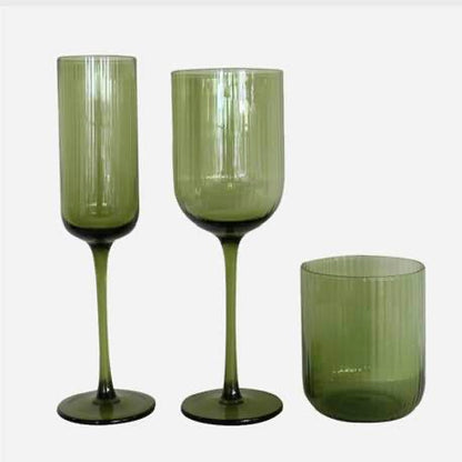 Set of three green glassware items on a white background
