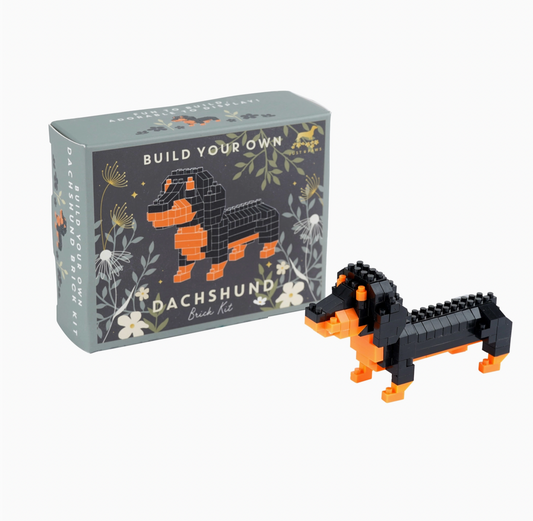 Build-your-own dachshund toy set with packaging on a white background