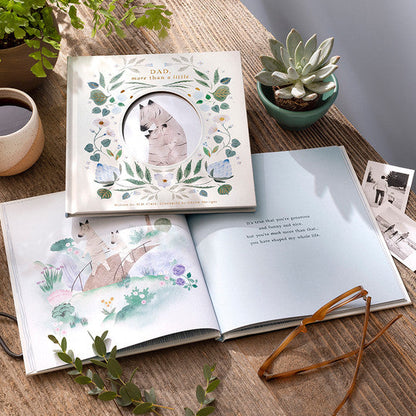 Children's book with illustrations on a wooden table with plants and a mug.