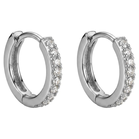 A pair of silver-toned huggie hoop earrings embellished with clear pavé gemstones on the front half, shown against a plain white background.
