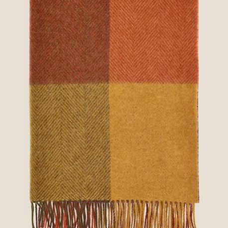 Checkered scarf with brown, red, and beige colors on a light background