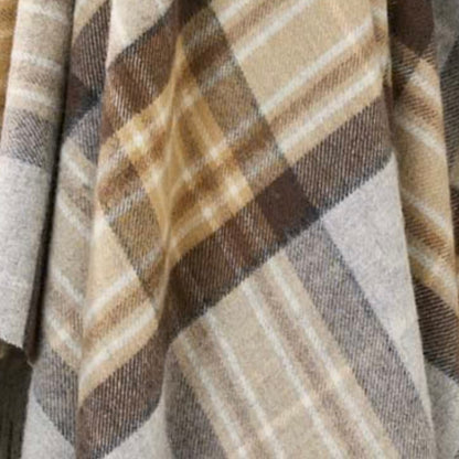 Close-up of a plaid fabric with brown, beige, and gray colors.