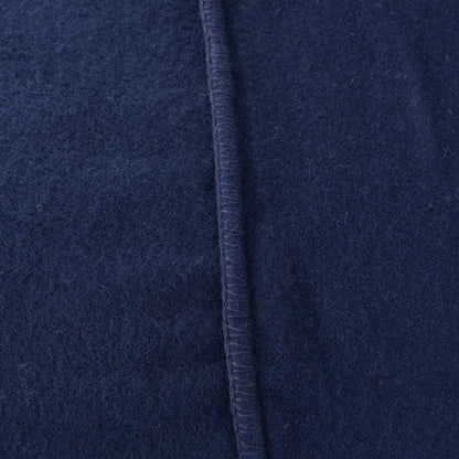 Close-up of a dark navy blue textured fabric with a vertical stitched seam.