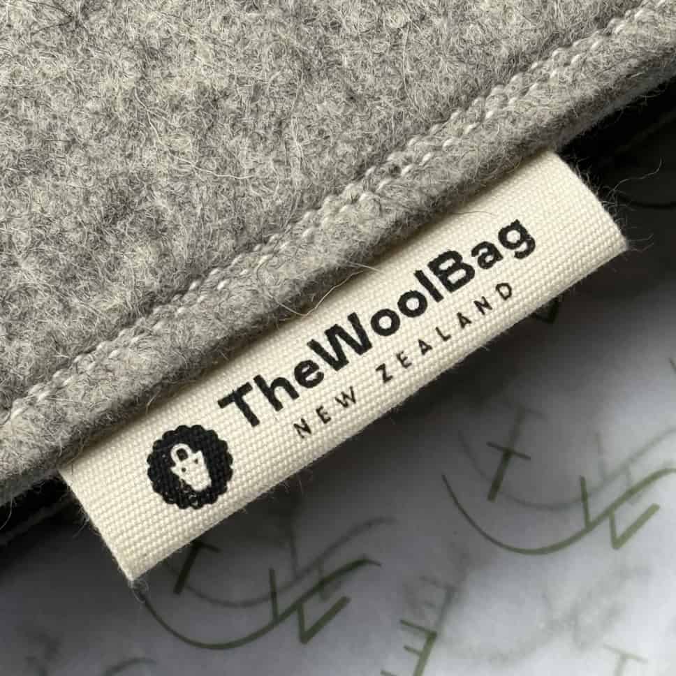 Label on a gray fabric product with 'TheWoolBag New Zealand' branding.