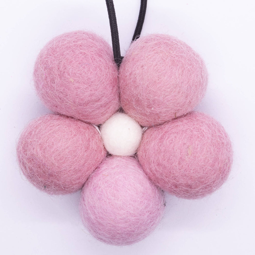 Pink felt ball flower necklace on a white background