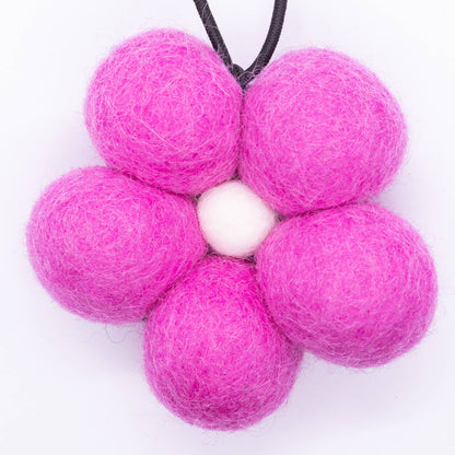 Pink felt ball flower on a white background