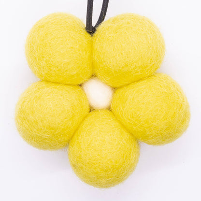 Yellow flower-shaped object with a central white circle on a white background