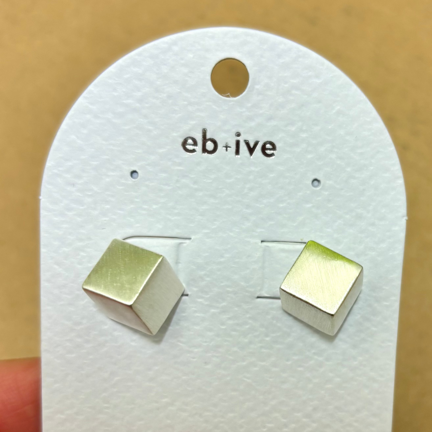 Silver cube earrings on white card
