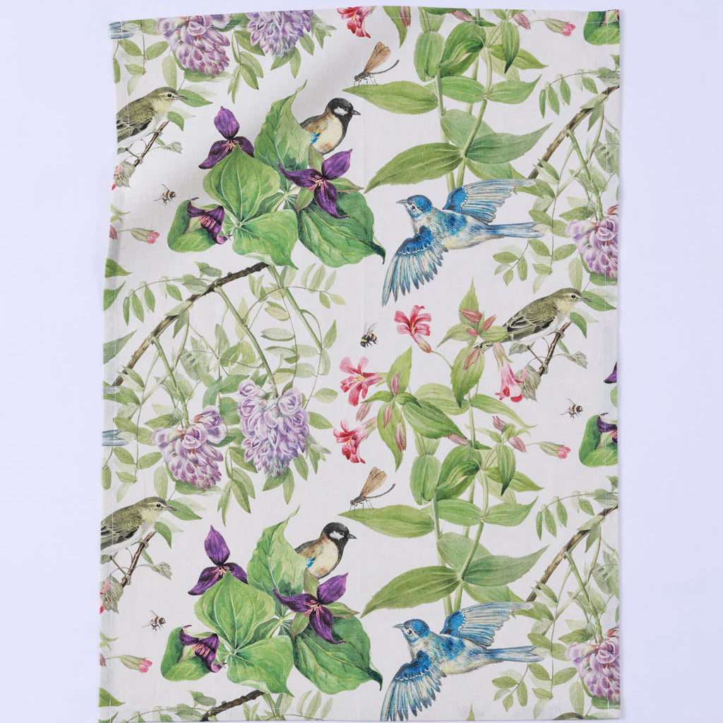 Floral and bird patterned fabric on a white background