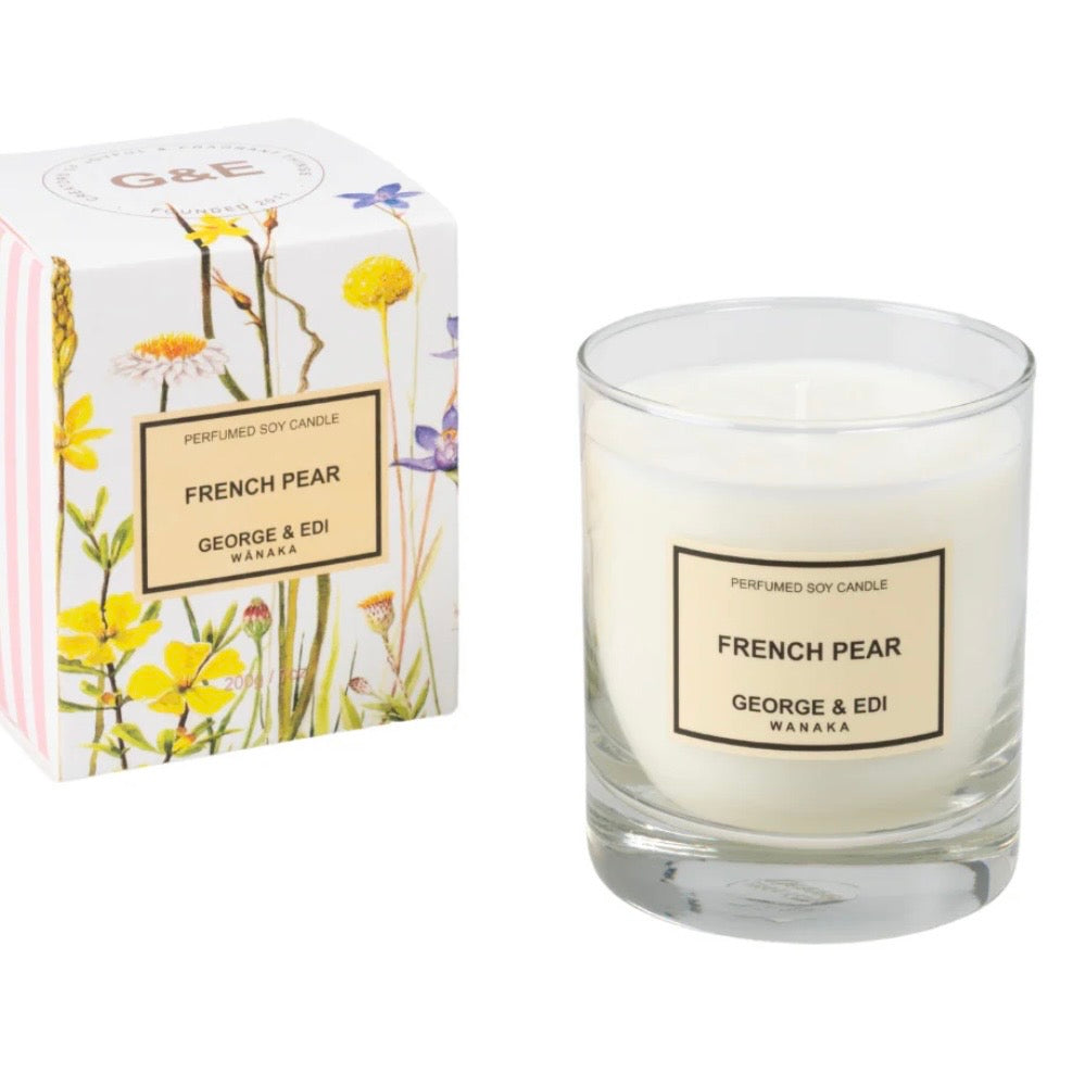 Glass candle labeled 'French Pear' by George & Edi with decorative packaging featuring floral designs.