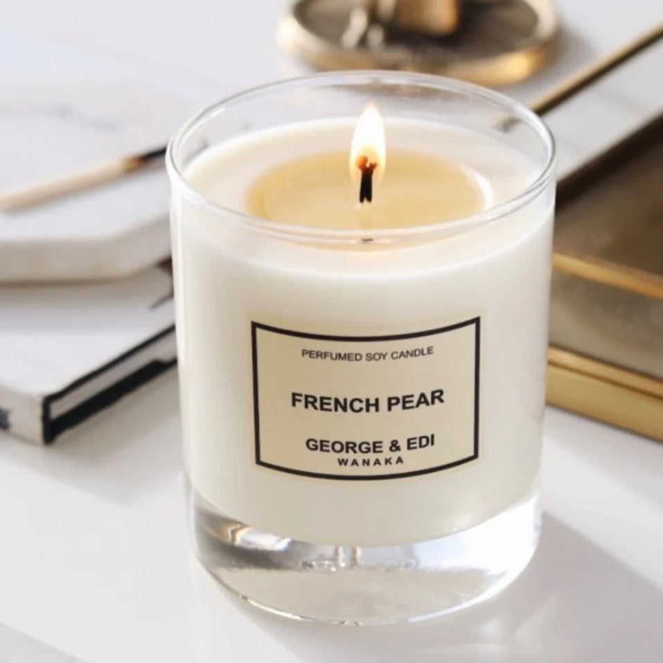 Candle labeled 'French Pear' by George & Edi on a white surface