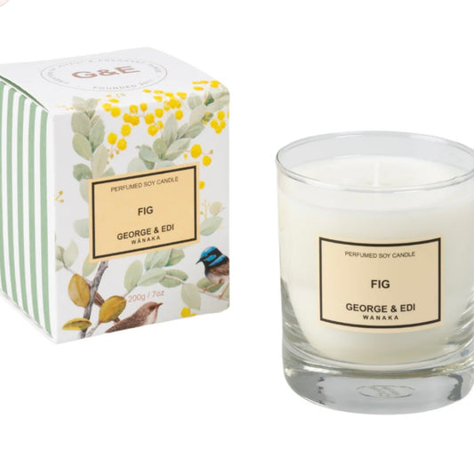 Candle and packaging with 'George & Edi' branding on a white background
