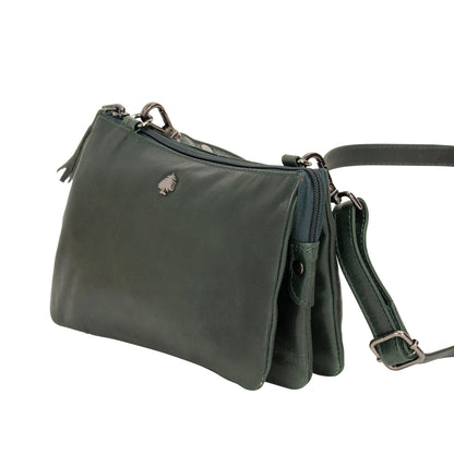 Green leather handbag with a strap on a white background