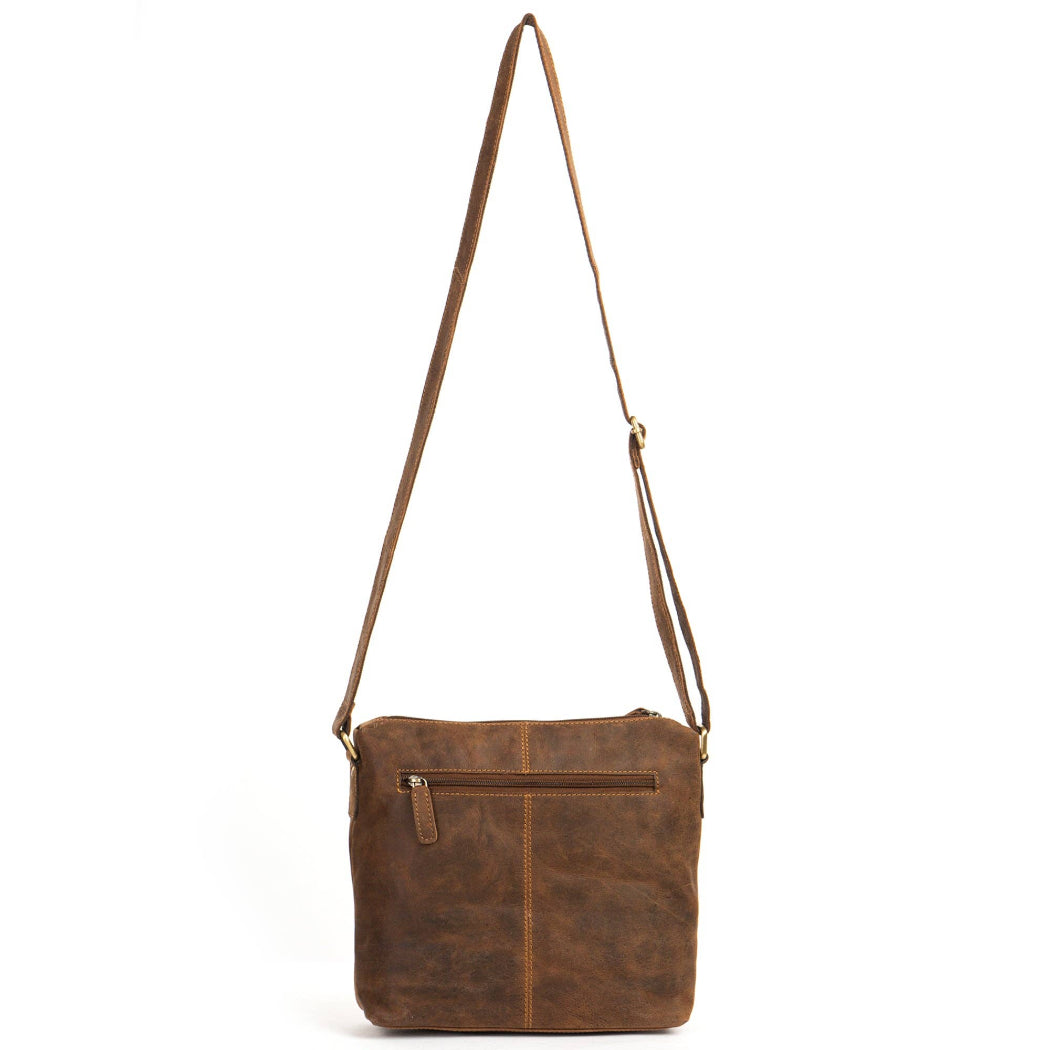 Brown leather crossbody bag with a strap on a white background