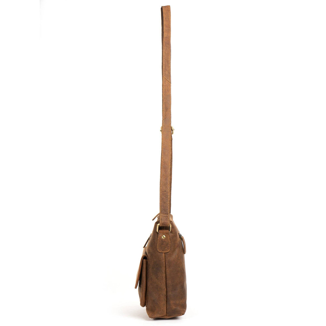 Brown leather bag with a strap on a white background