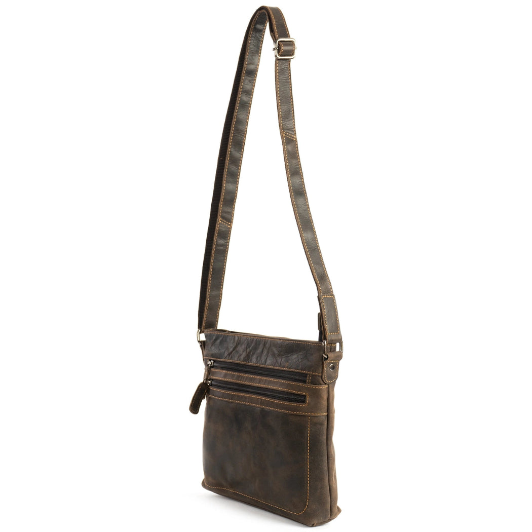 Brown leather crossbody bag with a strap on a white background