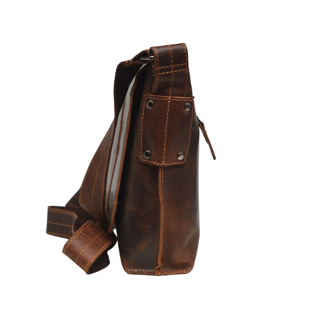 Brown leather bag with a strap on a white background
