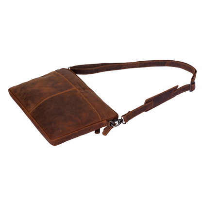 Brown leather bag with a strap on a white background
