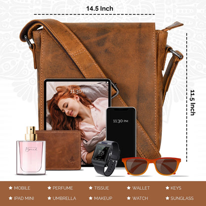 A brown faux-leather crossbody bag shown with its strap laid out, surrounded by included accessories such as a tablet, phone, perfume bottle, wallet, smartwatch, sunglasses, and keys. White dimension labels indicate 14.