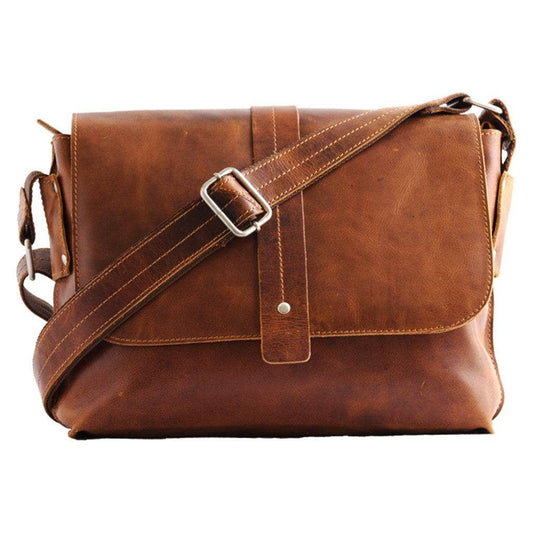 Brown leather messenger bag with a strap on a white background