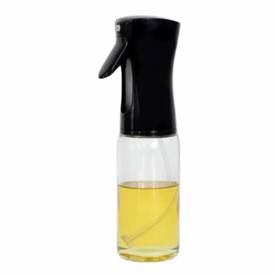 Clear glass bottle with black spray top containing a yellow liquid on a white background