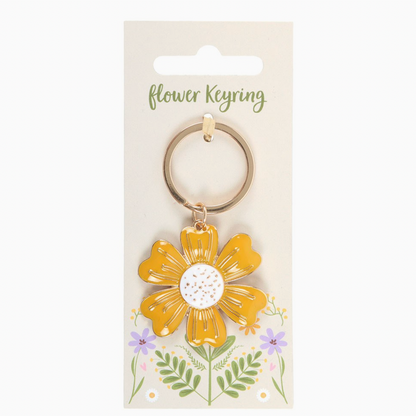 Yellow flower keyring on a white card with floral designs
