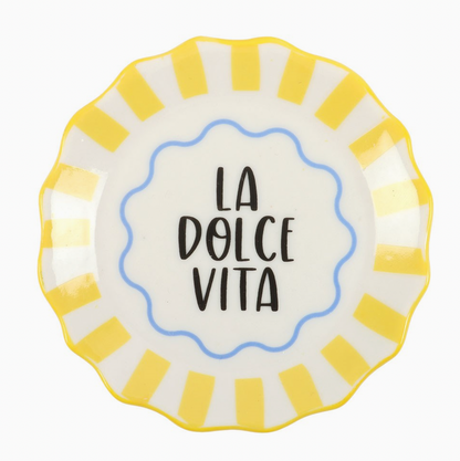 Decorative plate with 'La Dolce Vita' text and yellow stripes on a white background