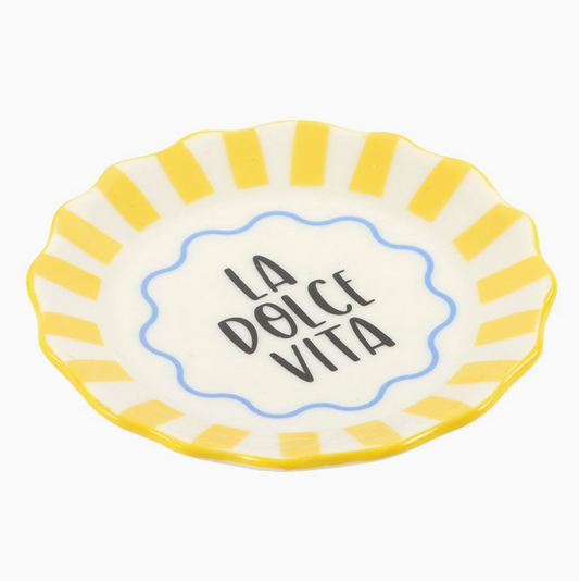 Small ceramic plate with yellow rim and 'La Dolce Vita' text on a white background