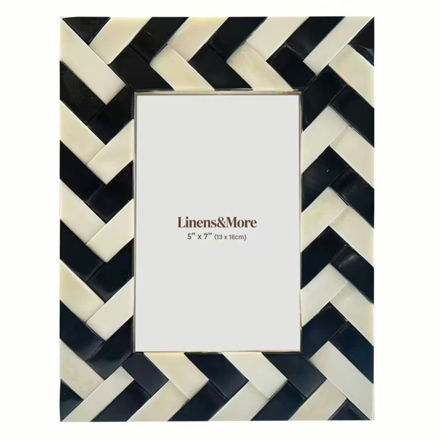 Picture frame with black and white chevron pattern on a white background