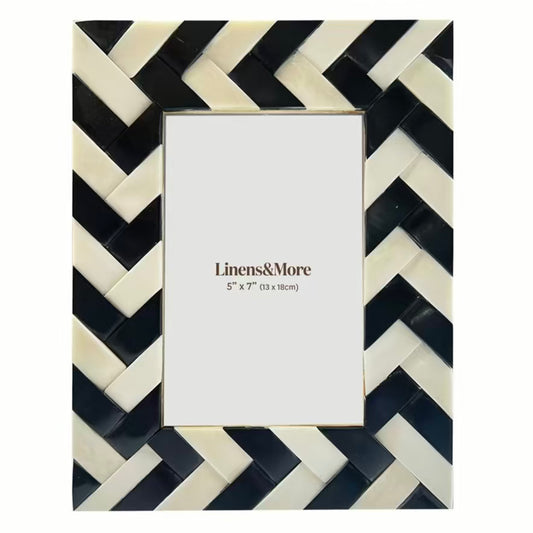 Picture frame with black and white chevron pattern on a white background
