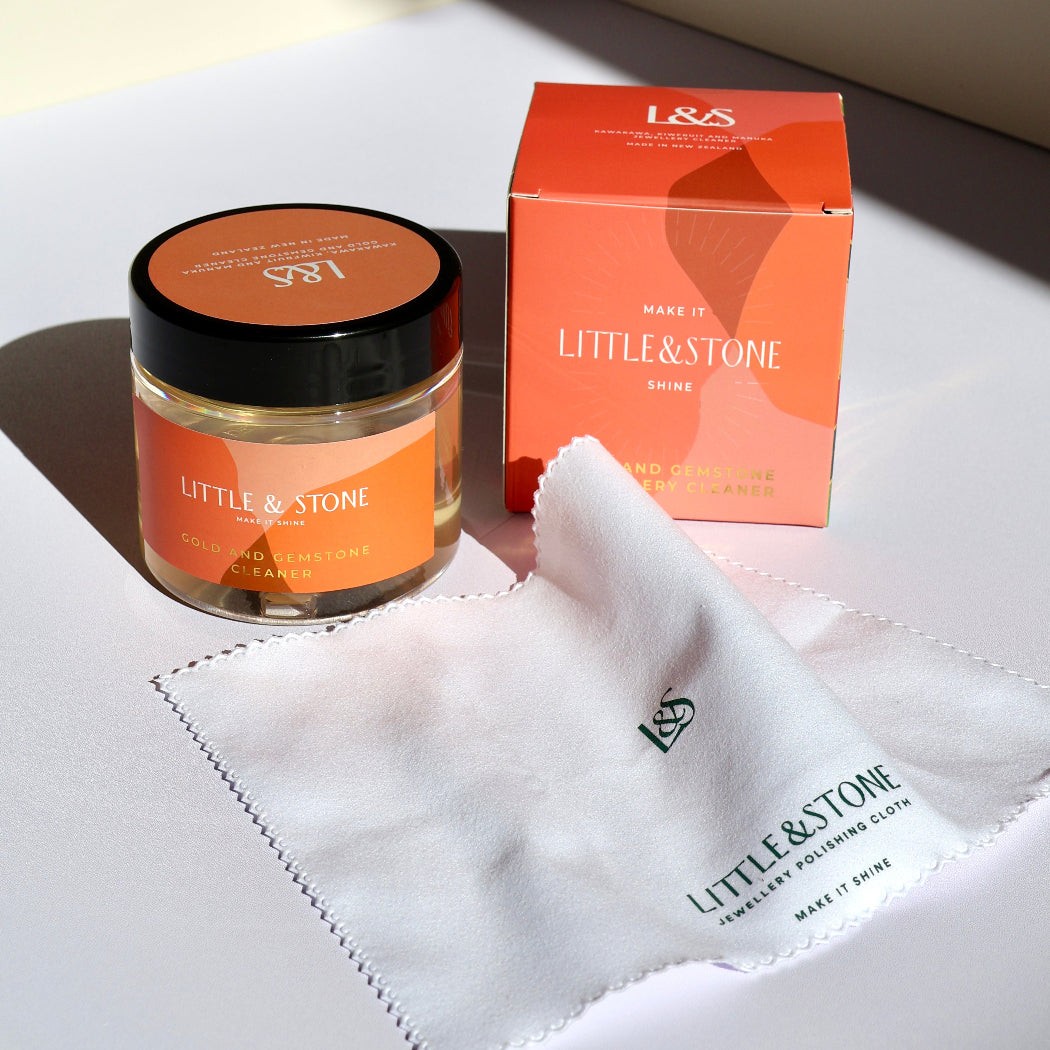 Little & Stone skincare product jar and box on a marble surface with soft lighting
