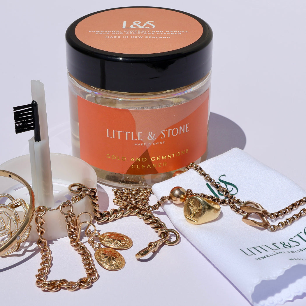 Jewelry set with 'Little & Stone' branded items on a white background